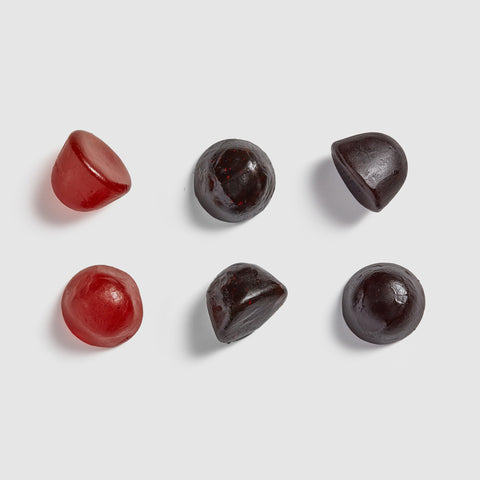 Three Juice Plus+ chewables on a light gray background