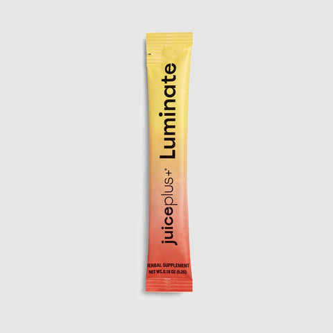 Juice Plus+ Luminate supplement packet on a light gray background