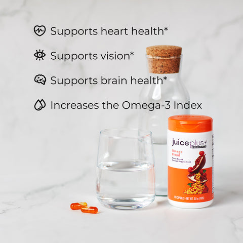 Juice Plus+ Omega Plus supplement bottle with a glass of water on a light background