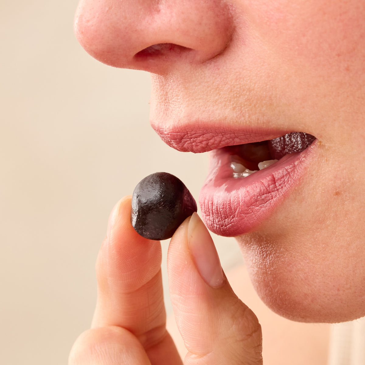 Close-up of a person holding and about to eat a Juice Plus+ chewable