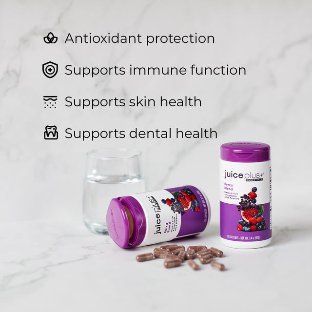 Juice Plus+ Berry capsules package on a marble background with text about product benefits.