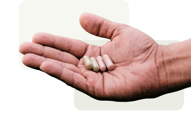 Open Hand holding four Juice Plus+ Capsules