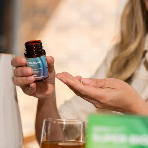 Superbiome duo modal holding bottle